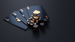 Black playing cards with gold aces, poker chips, and dice on dark surface