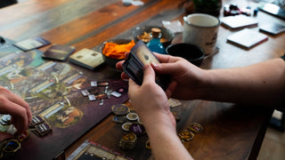two people playing a board game on a table