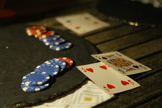Poker chips and playing cards on a dark table